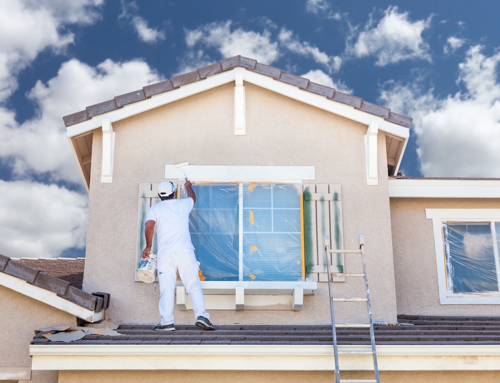 Professional House Painter Painting the Trim And Shutters of A Home in Portland 